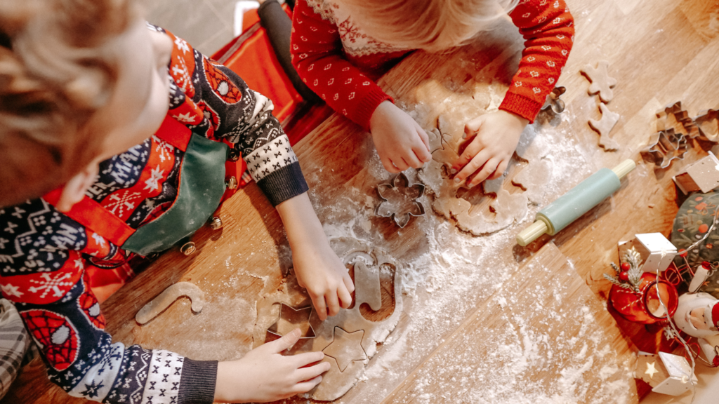 Two-Children-Making-Christmas-Cookies-on-a-floured-table