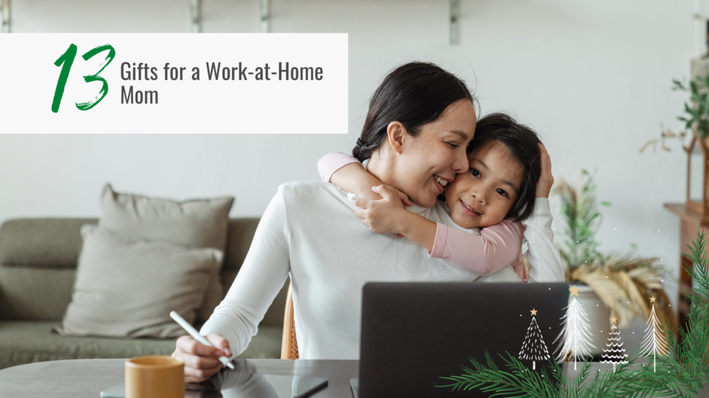 work at home mom at her desk with young daughter hugging her from behind