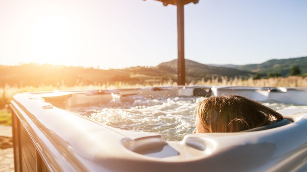 mom relaxing in a hot tub with a great view