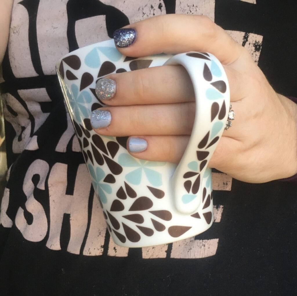 work at home mom with dip nails and a coffee cup